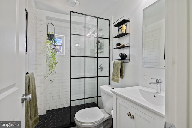 full bath with a stall shower, toilet, and vanity