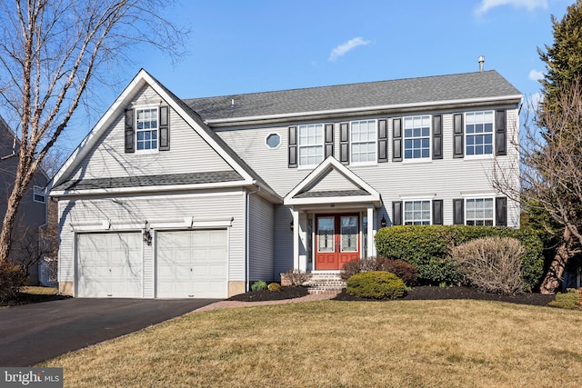 view of front of home featuring a front yard, a garage, driveway, and roof with shingles