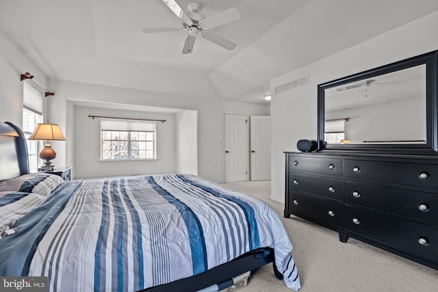 carpeted bedroom with visible vents and ceiling fan