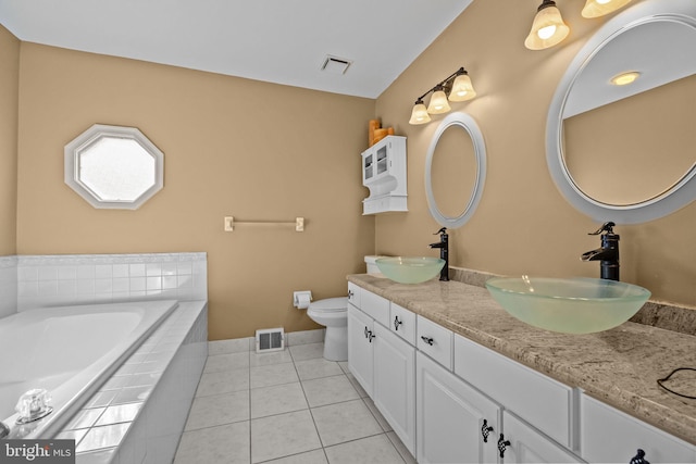 bathroom featuring a sink, visible vents, and tile patterned flooring