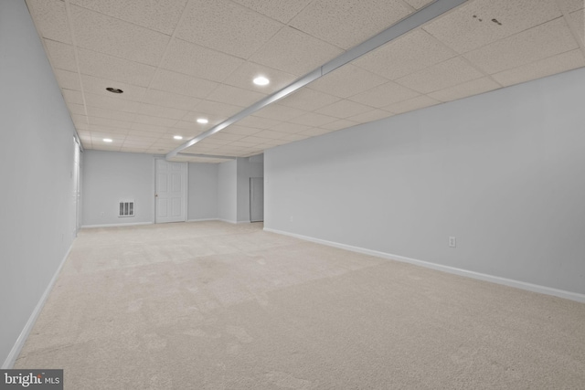 finished basement featuring visible vents, carpet, and baseboards