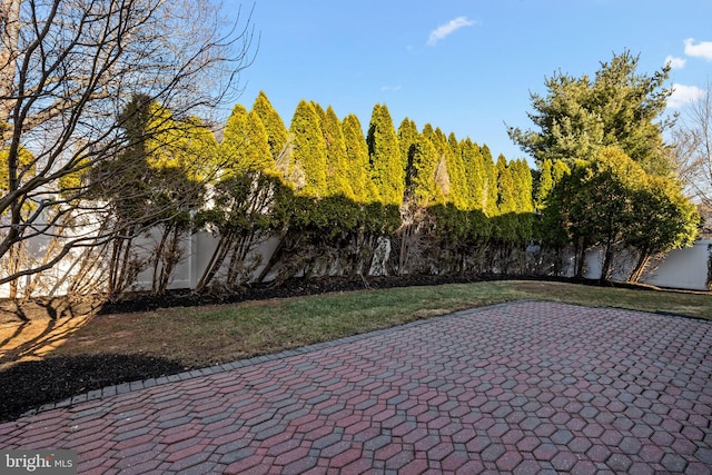 view of patio featuring fence