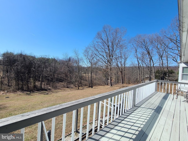 wooden deck with a forest view