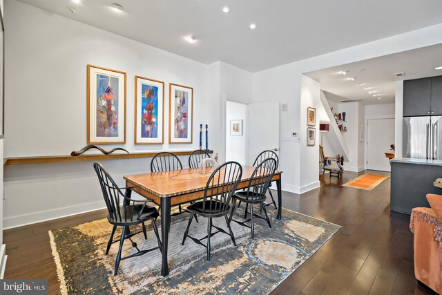 dining room featuring recessed lighting, dark wood-type flooring, and baseboards