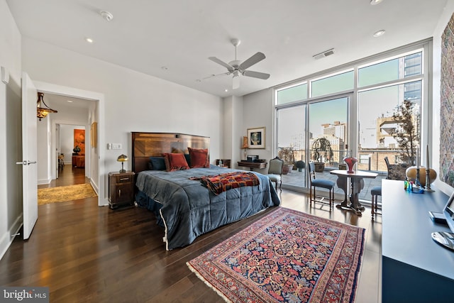 bedroom with visible vents, floor to ceiling windows, hardwood / wood-style floors, recessed lighting, and access to outside