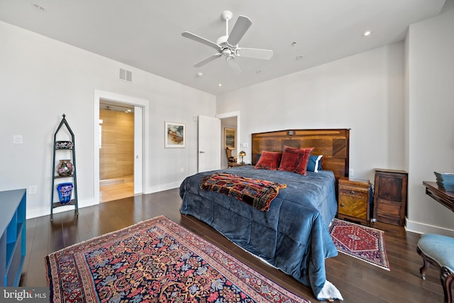 bedroom with visible vents, a ceiling fan, baseboards, and hardwood / wood-style floors