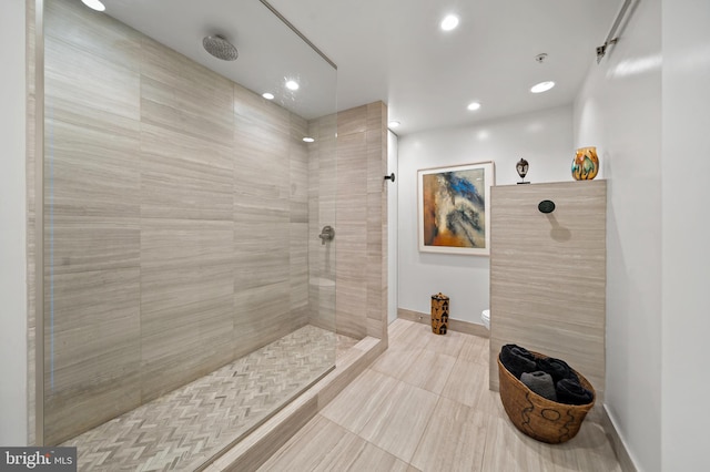 bathroom with toilet, recessed lighting, a walk in shower, and baseboards