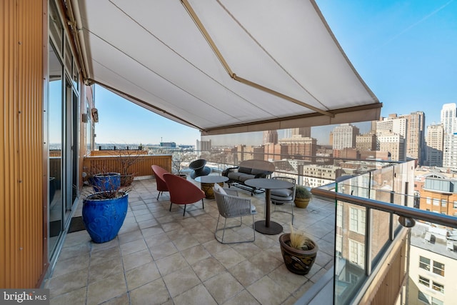 view of patio featuring a view of city and a balcony