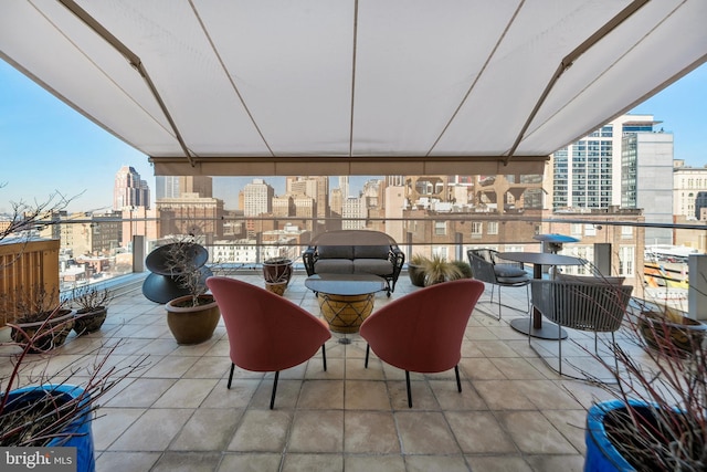 view of patio featuring a balcony and a city view