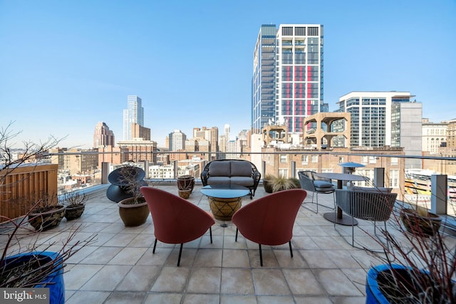 view of patio / terrace with a balcony and a view of city