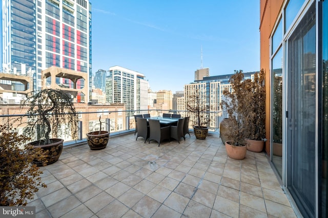 view of patio with a view of city and a balcony