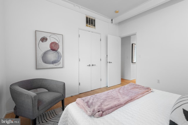 bedroom featuring light wood finished floors and a closet