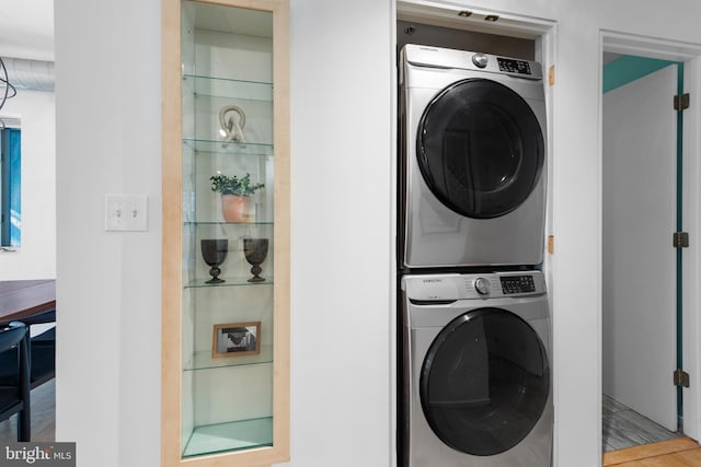 washroom with laundry area and stacked washer / dryer