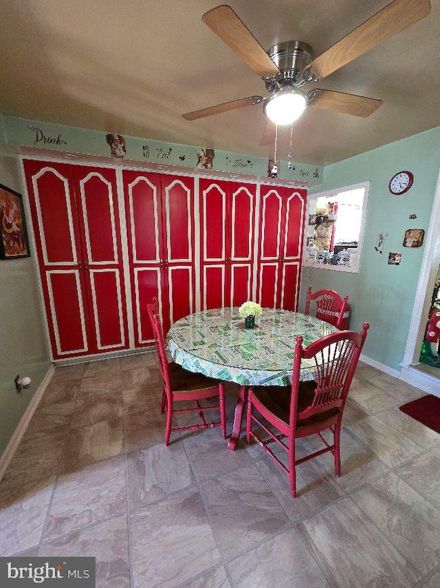 dining room with ceiling fan and baseboards