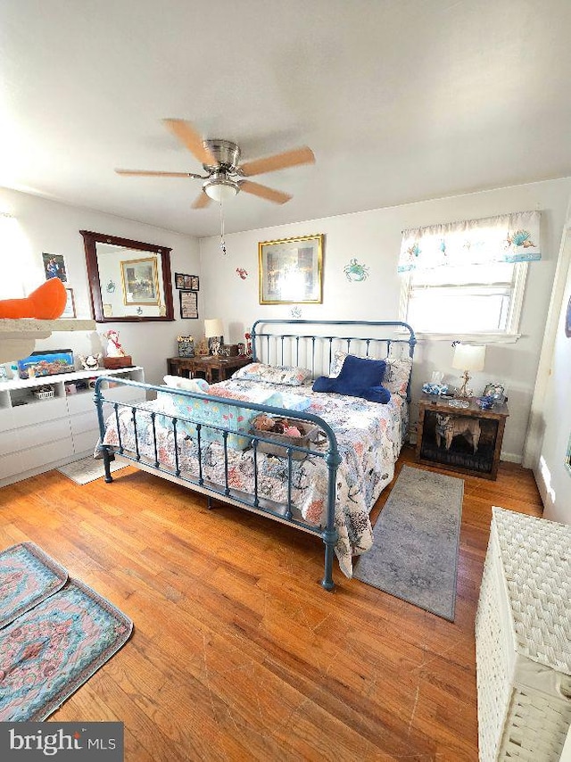 bedroom featuring a ceiling fan and wood-type flooring