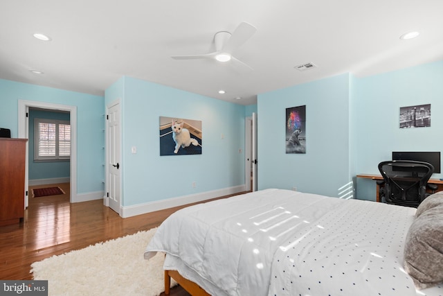 bedroom featuring recessed lighting, visible vents, baseboards, and wood finished floors