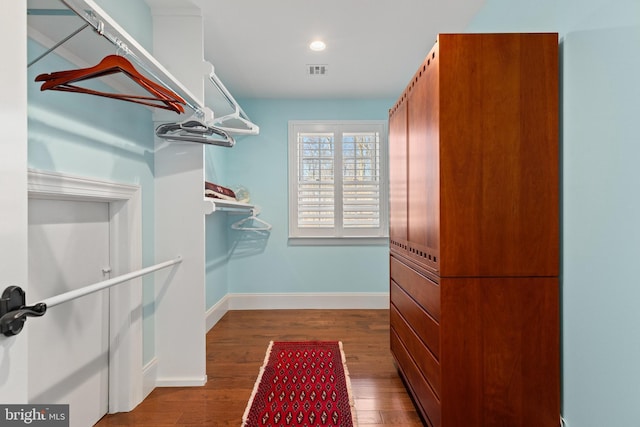 walk in closet featuring visible vents and wood finished floors