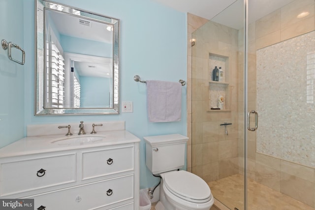 full bathroom featuring vanity, a shower stall, toilet, and visible vents