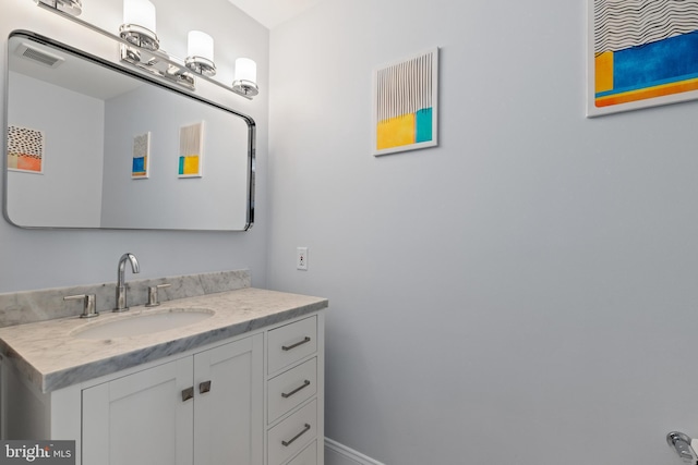 bathroom with visible vents, baseboards, and vanity