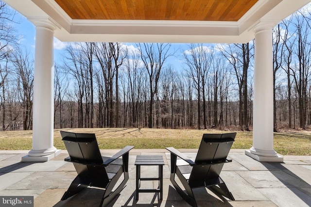 view of patio with a wooded view