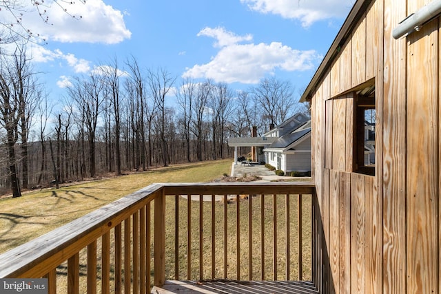 wooden terrace featuring a yard