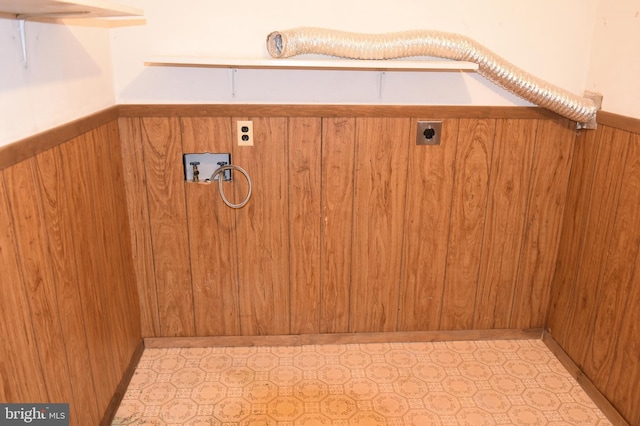 interior details with wooden walls and a wainscoted wall