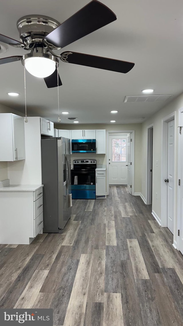 kitchen featuring white cabinetry, dark wood-style floors, a ceiling fan, and appliances with stainless steel finishes