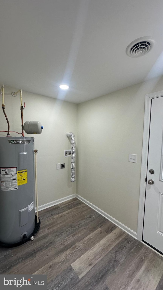 utility room featuring visible vents and water heater