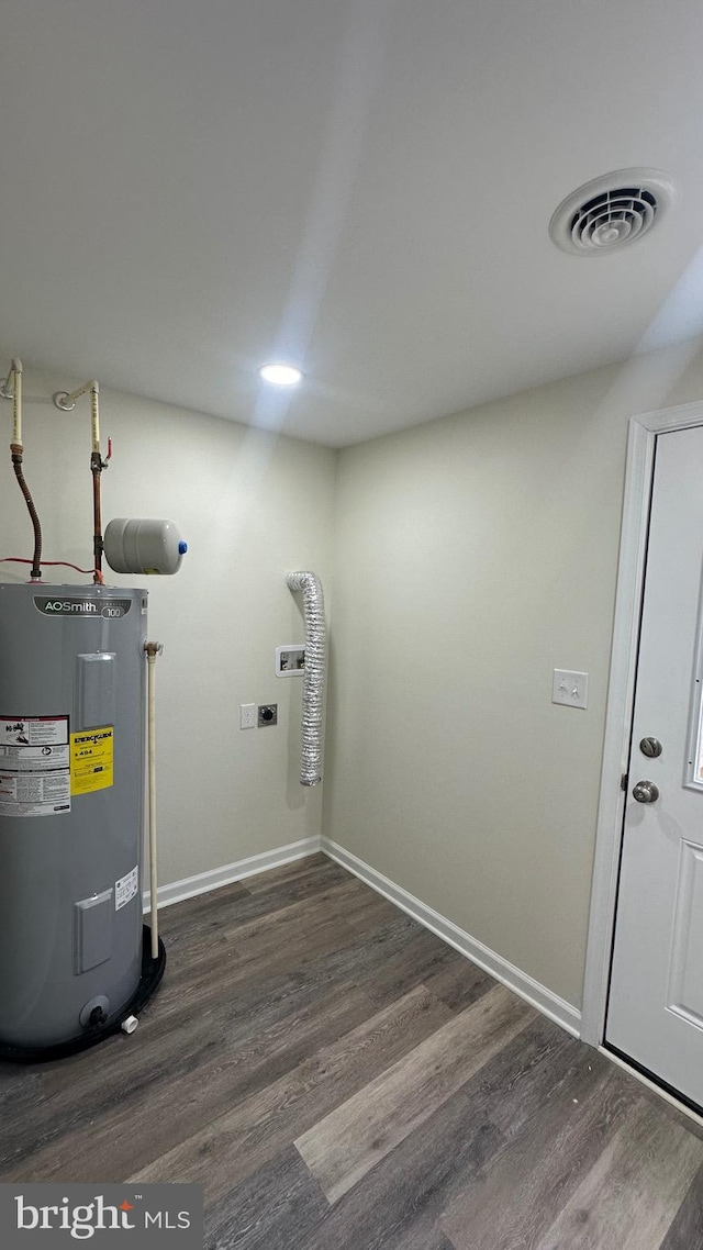 utility room with visible vents and electric water heater