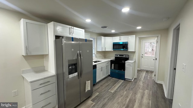 kitchen with light countertops, visible vents, appliances with stainless steel finishes, and a sink