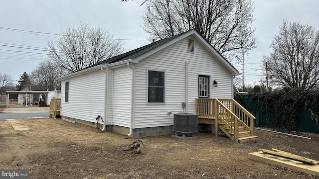 rear view of house featuring central AC