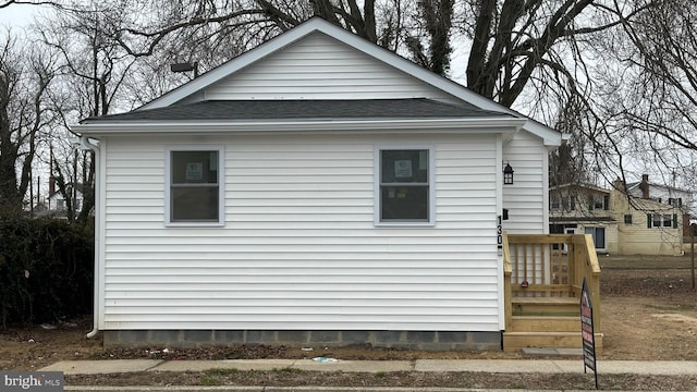 view of home's exterior with a shingled roof