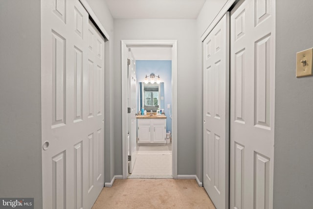 10 White Pine Ct, Lafayette Hill, PA 19444 - hallway with light carpet, baseboards, and a sink