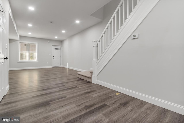 interior space featuring recessed lighting, stairway, baseboards, and wood finished floors