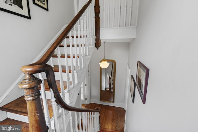 stairway featuring wood finished floors