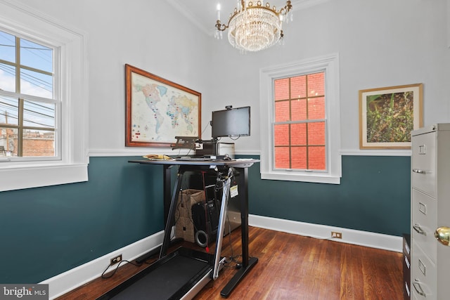 office area featuring an inviting chandelier, crown molding, baseboards, and dark wood-style flooring