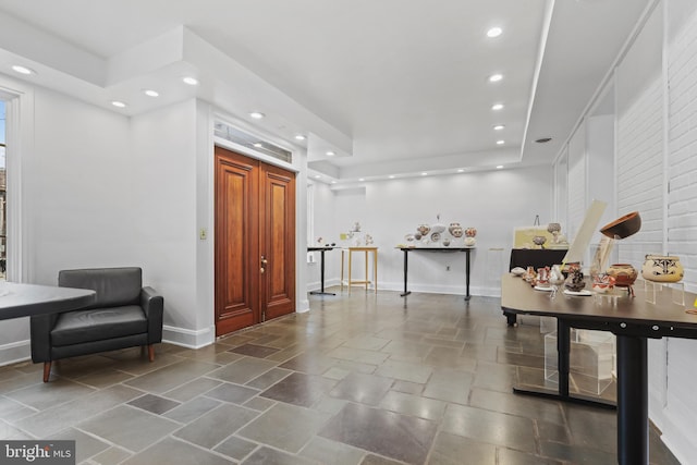 interior space with stone finish floor, recessed lighting, and baseboards