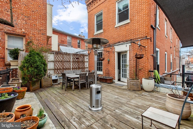 deck with outdoor dining space and fence