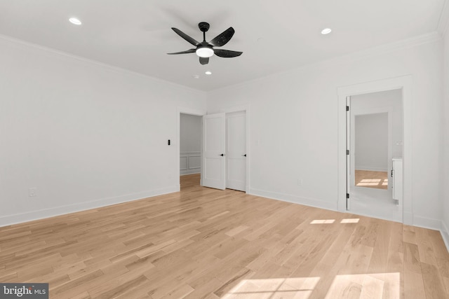 unfurnished bedroom with crown molding, baseboards, and light wood-type flooring