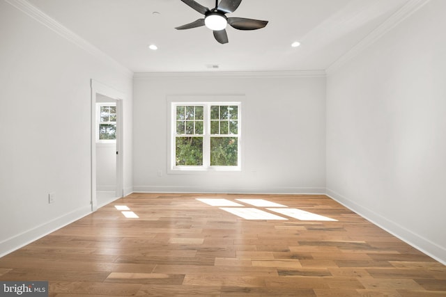 empty room with recessed lighting, baseboards, crown molding, and light wood finished floors