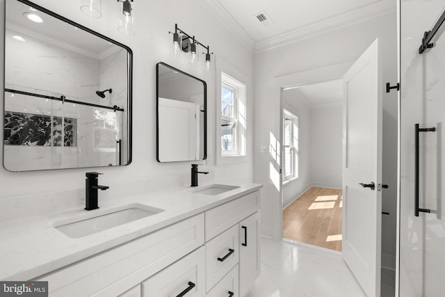 bathroom with crown molding, visible vents, a marble finish shower, and a sink