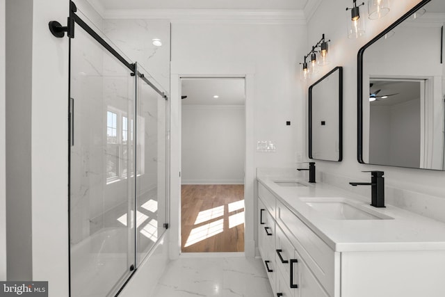 bathroom with double vanity, ornamental molding, marble finish floor, and a sink