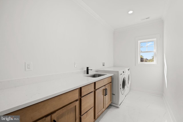 laundry area with marble finish floor, washer and clothes dryer, a sink, cabinet space, and crown molding