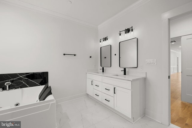 bathroom featuring baseboards, a sink, ornamental molding, a jetted tub, and marble finish floor