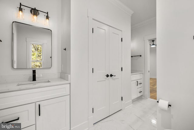 full bathroom featuring marble finish floor, vanity, and crown molding