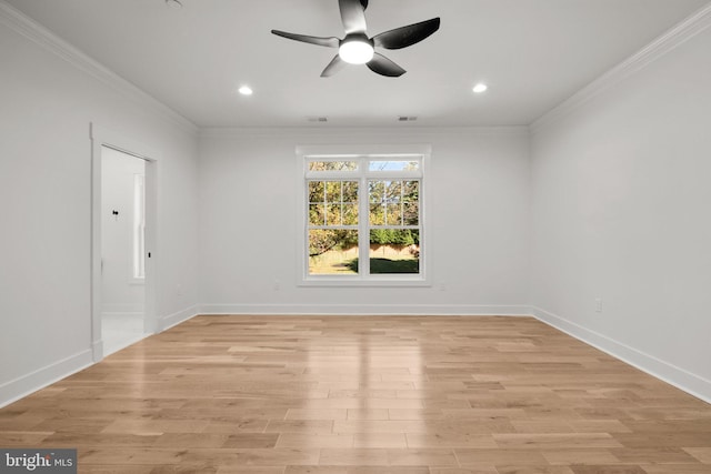 unfurnished room featuring visible vents, light wood-type flooring, baseboards, and ornamental molding