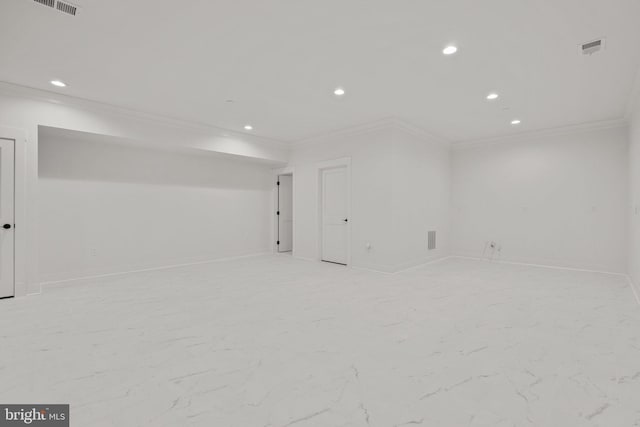 below grade area with visible vents, recessed lighting, marble finish floor, and crown molding