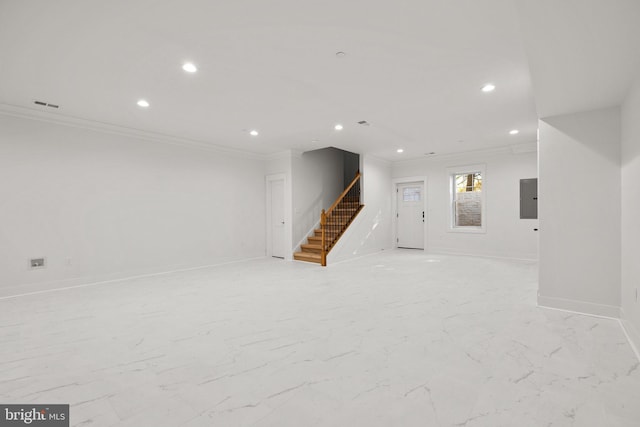 below grade area featuring visible vents, electric panel, crown molding, baseboards, and stairs