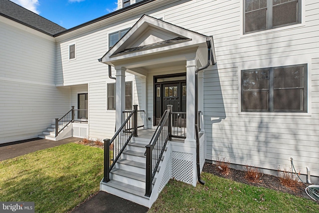 doorway to property featuring a yard