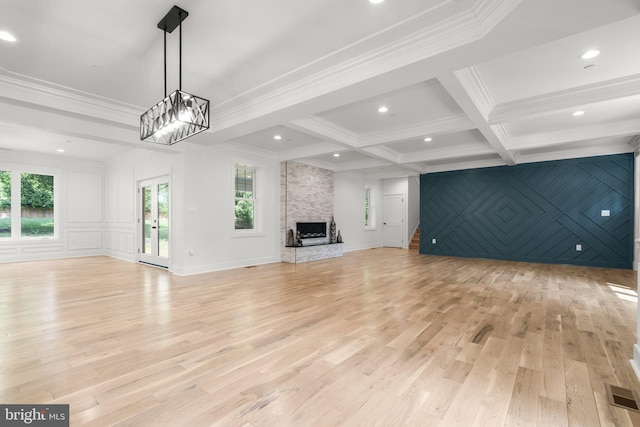 4507 Muncaster Mill Rd, Rockville, MD 20853 - unfurnished living room featuring crown molding, light wood-type flooring, a decorative wall, beam ceiling, and a fireplace
